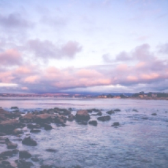 Heavy clouds reflect the pink setting sun in Lover's Point of Monterey Bay, CA NotSoSAHM